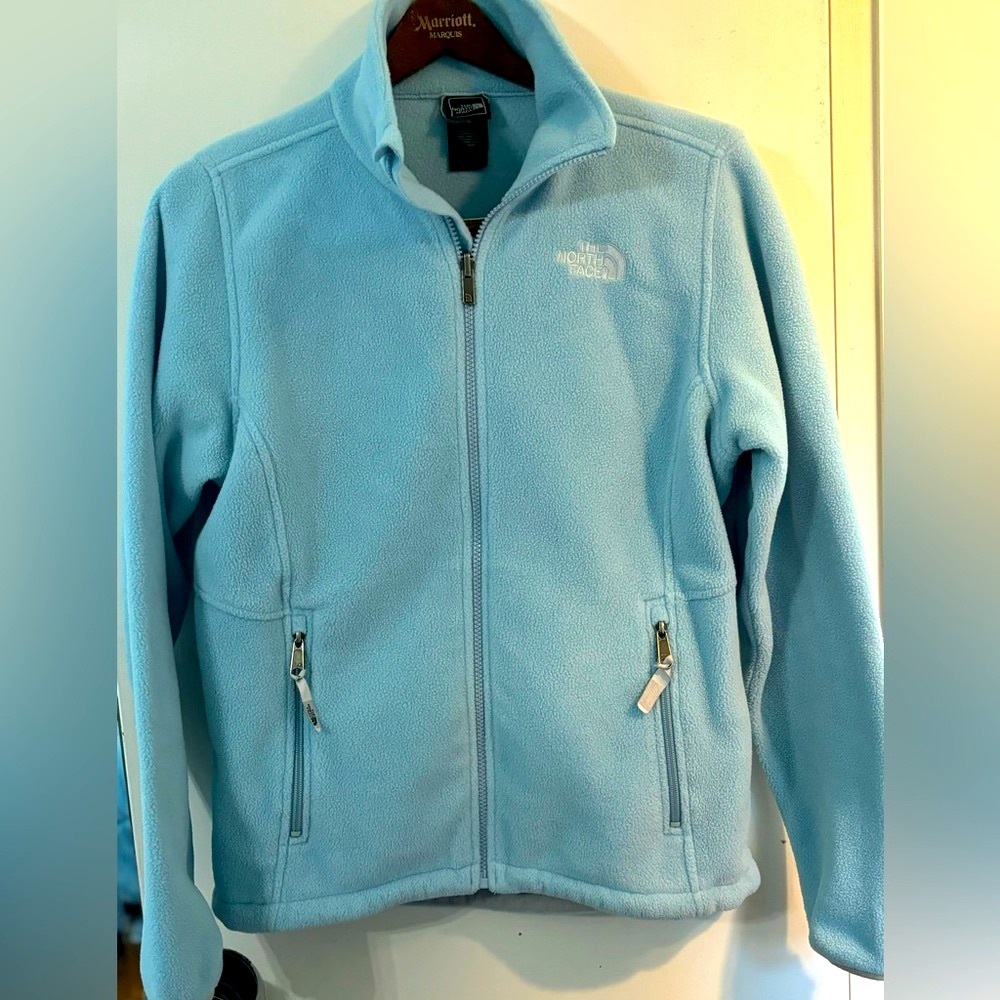The North Face light blue woman’s zip up jacket size medium.